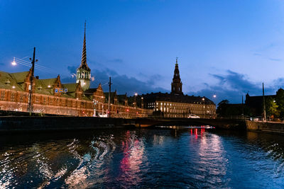 River with illuminated buildings in background