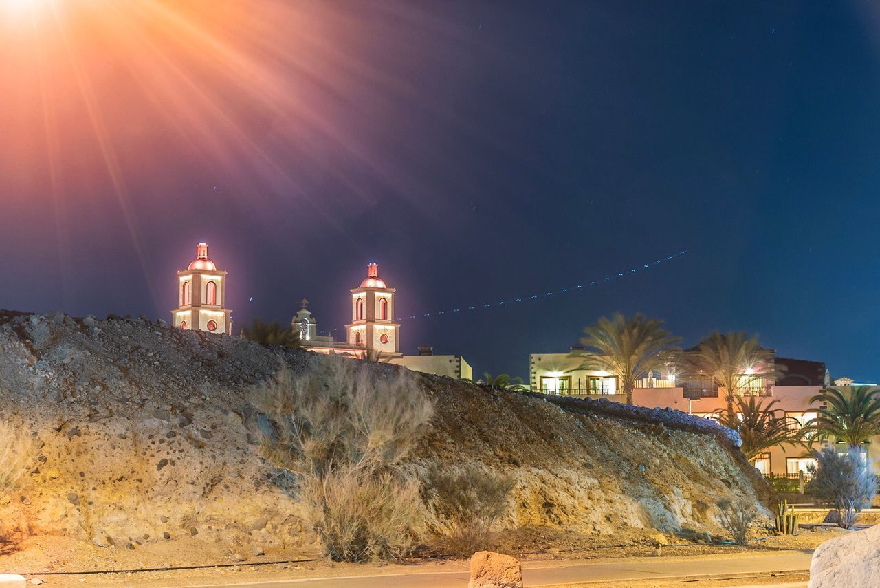 VIEW OF ILLUMINATED BUILDINGS AGAINST SKY AT NIGHT