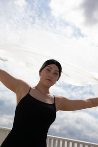 Portrait of woman standing against sky