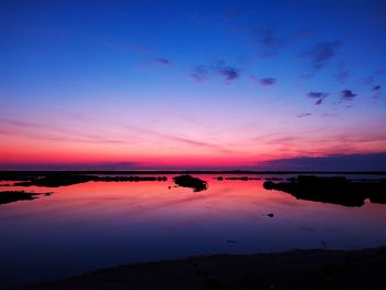 Scenic view of sea against romantic sky at sunset