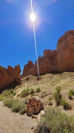 Low angle view of rocks against blue sky