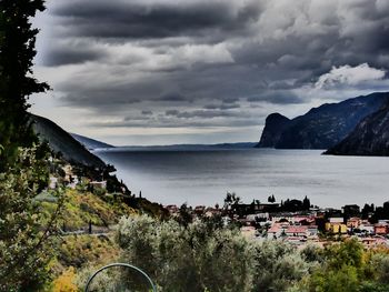 Scenic view of sea by buildings against sky