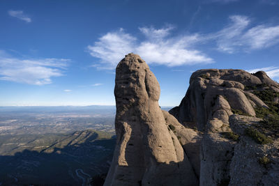 Rock formations on landscape against sky