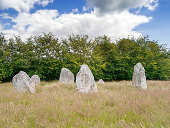 Hay bales on field against sky