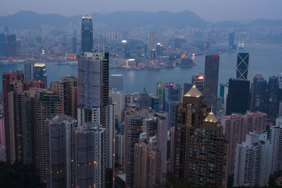 High angle view of illuminated city buildings against sky