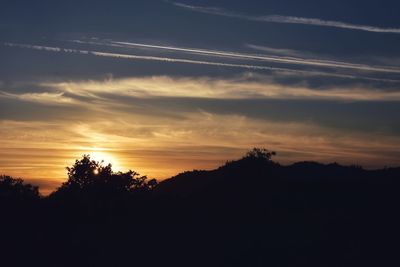 Scenic view of silhouette mountains against sky at sunset