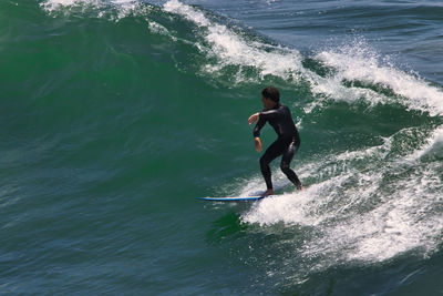 Full length of man surfing in sea