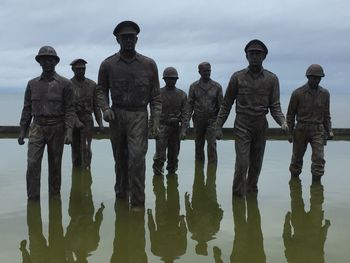 Group of people in water against sky