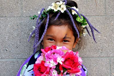 Portrait of woman holding pink flower