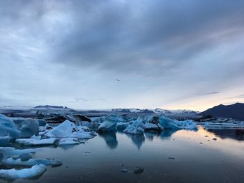 Scenic view of frozen lake against sky during winter