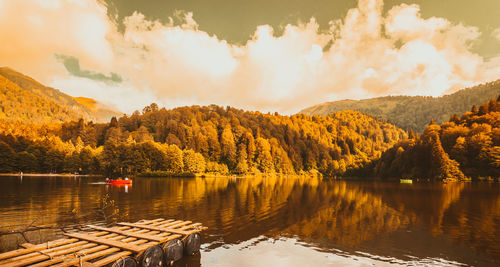 Scenic view of lake by trees against sky during autumn