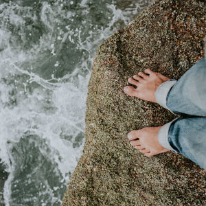 Low section of woman relaxing in water