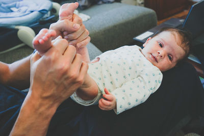 Midsection of father and son on hands