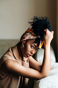 Portrait of young woman lying on bed