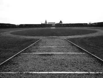 Empty road on field against clear sky