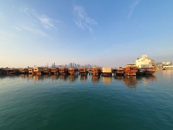 Panoramic view of sea and buildings in city against sky
