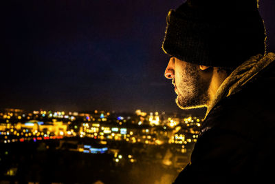 Close-up of illuminated cityscape against sky at night