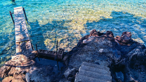 High angle view of abandoned rock by sea