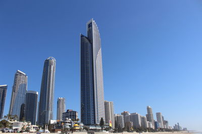 Low angle view of buildings against clear blue sky