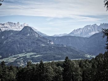 Scenic view of mountains against cloudy sky