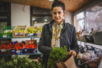 Portrait of young man standing in market