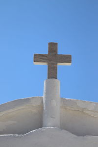 Low angle view of cross against blue sky