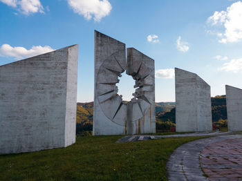 Built structure on field against sky in city