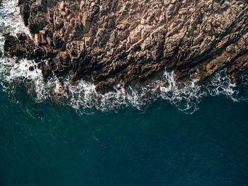 High angle view of rock formation in sea