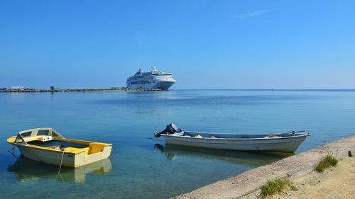 Ship moored on sea against clear sky