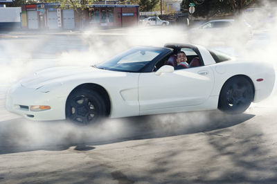 Mechanic drifting car on road