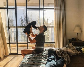 Couple sitting by window at home