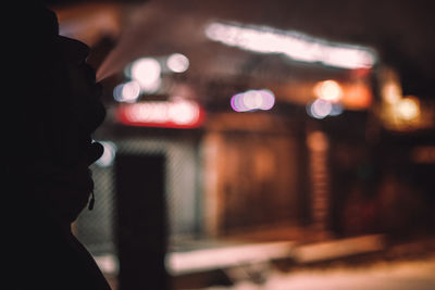 Rear view of woman looking at camera