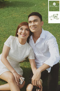 Portrait of young couple sitting outdoors