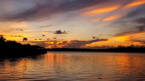 Scenic view of lake against orange sky