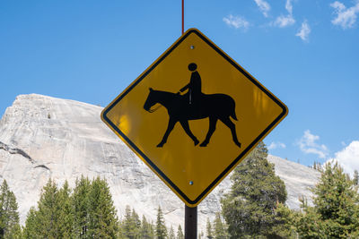 Low angle view of road sign against sky