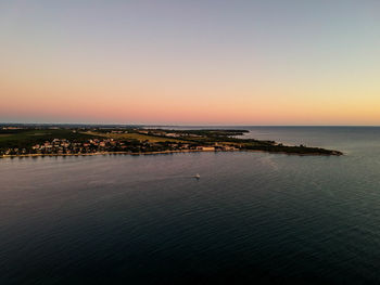 Scenic view of sea against clear sky during sunset