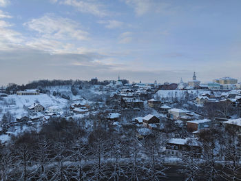 Aerial view of townscape against sky during winter