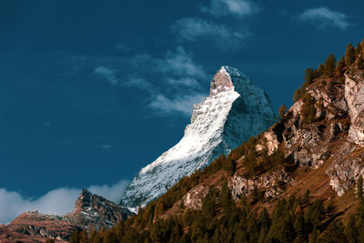 Scenic view of snow covered mountains against sky