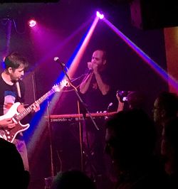 Group of people playing guitar at night