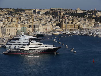 Aerial view of cityscape by sea against sky