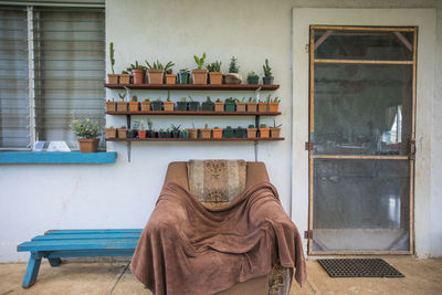 Simple living, comfy and cozy outdoor space on front porch of house.