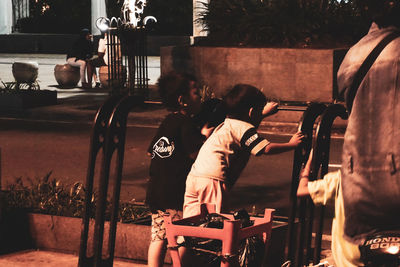 Rear view of people playing piano
