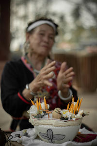 Woman holding ice cream in bowl on table