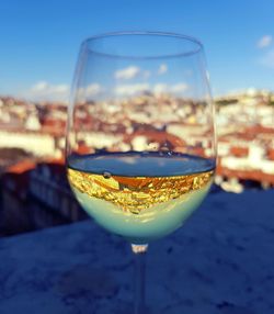 Close-up of beer in glass against blue sky