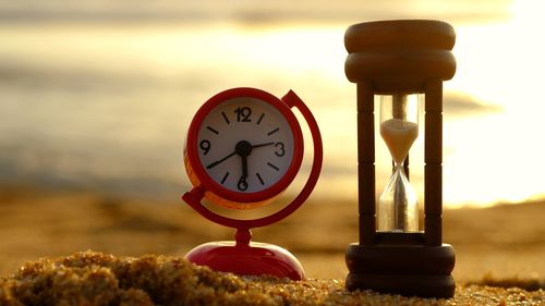 Close-up of clock on table at beach