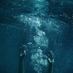 Cropped image of person swimming in sea