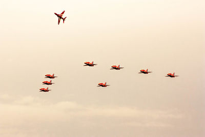 Low angle view of airshow against sky