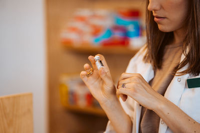 Midsection of woman using mobile phone