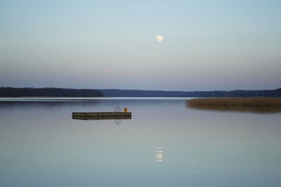 Scenic view of lake against sky at dusk