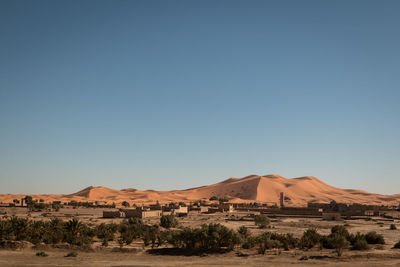 Scenic view of desert against clear blue sky